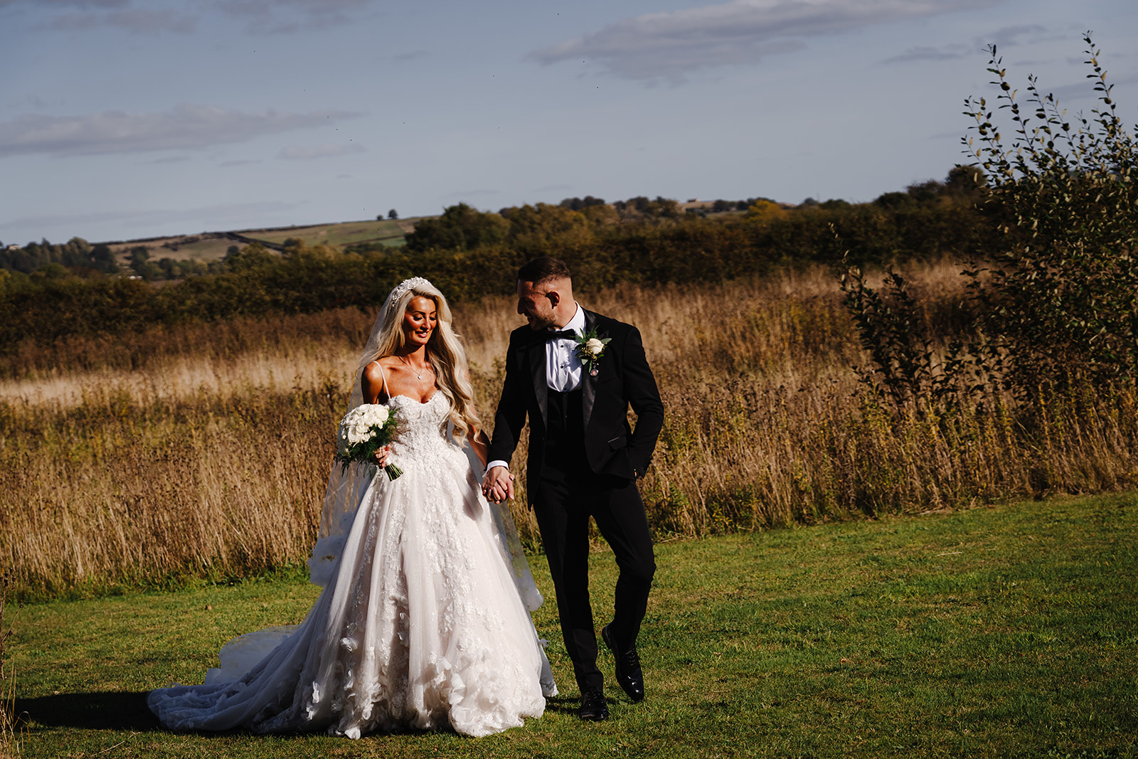 Antonia and Lee walking hand in hand at Wharfedale Grange