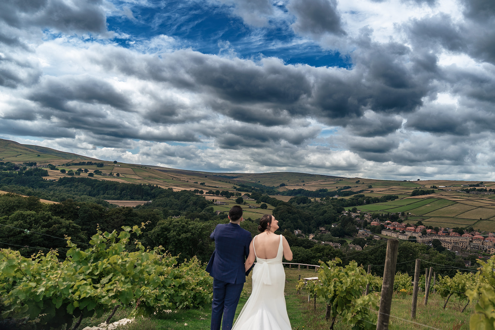 Chloe and Jordan among the vineyard rows beneath cloudy skies at Holmfirth Vineyard